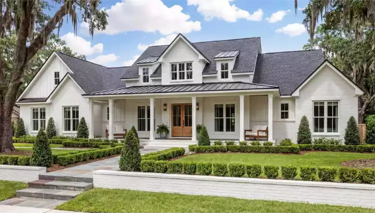 A well-kept white home exterior at dusk